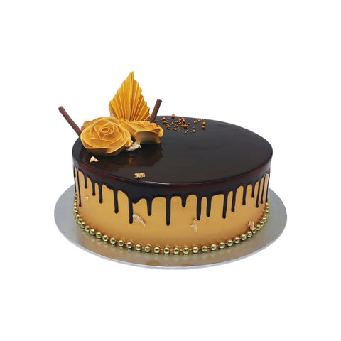 Chocolate cake with gold accents and a decorative.