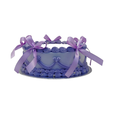 Decorative purple cake with ribbons on a white background