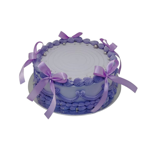 Decorative cake with purple ribbons and decorative elements on a white background