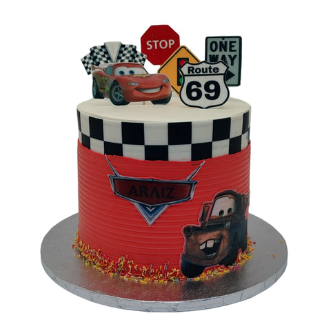 Cars Cake decorated with cartoon characters and racing elements on a white background. Cars Cakes.